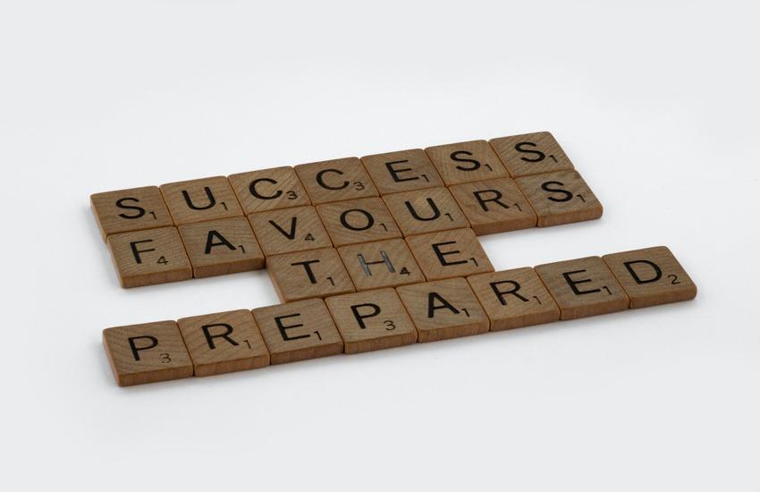 Scrabble tiles spelling "success favors the prepared"
